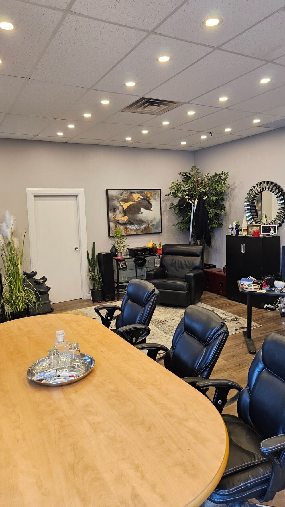 Bright reception and waiting area with modern flooring, pot lighting and large front windows