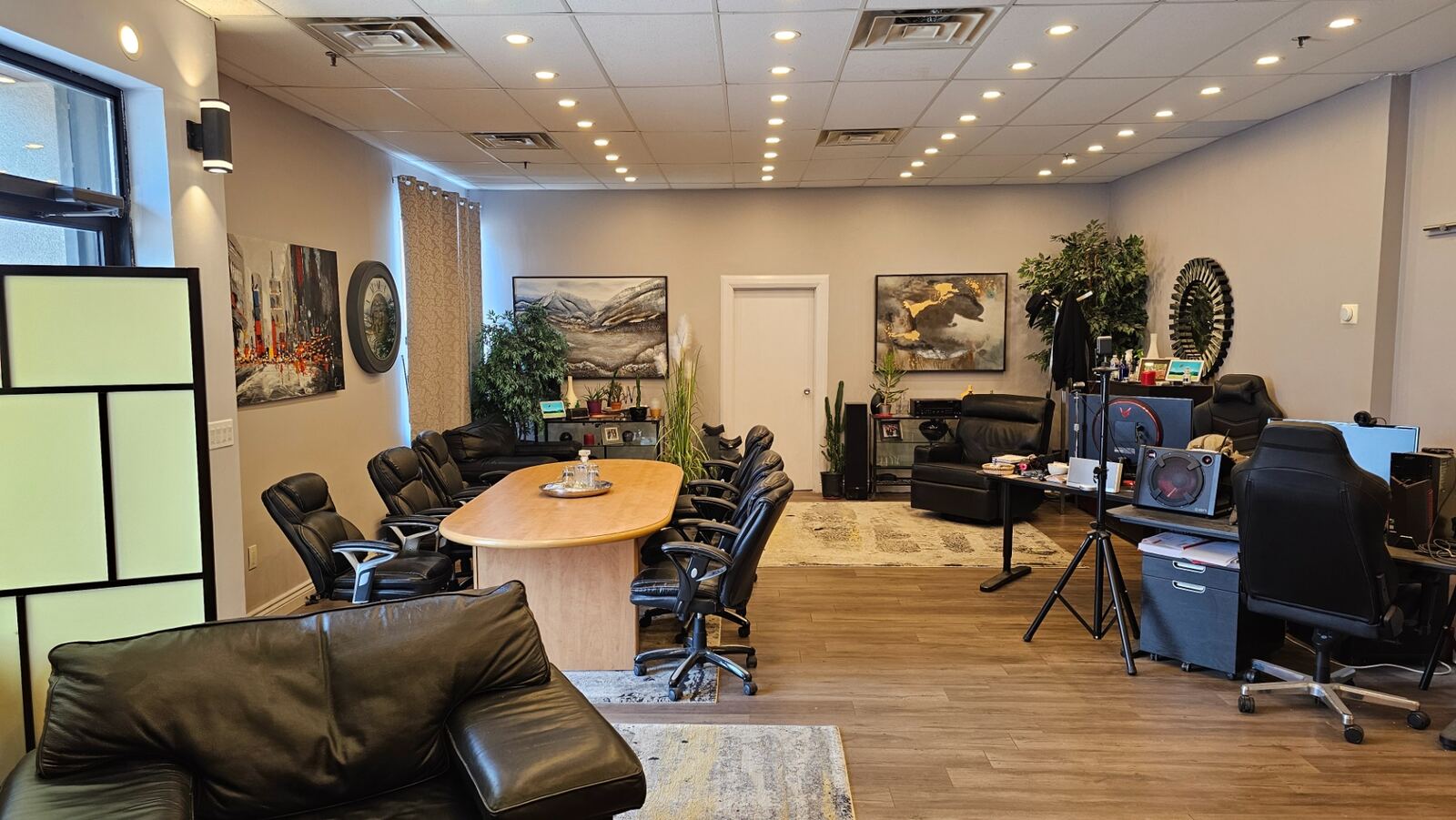 Main floor open office and boardroom area with conference table and lounge seating